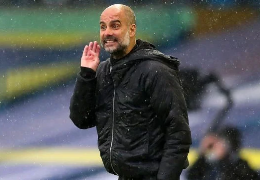 Pep Guardiola watches on under the rain — a familiar Premier League setting he joked about with Sean Dyche.