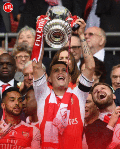 Xhaka lifting a trophy with Arsenal